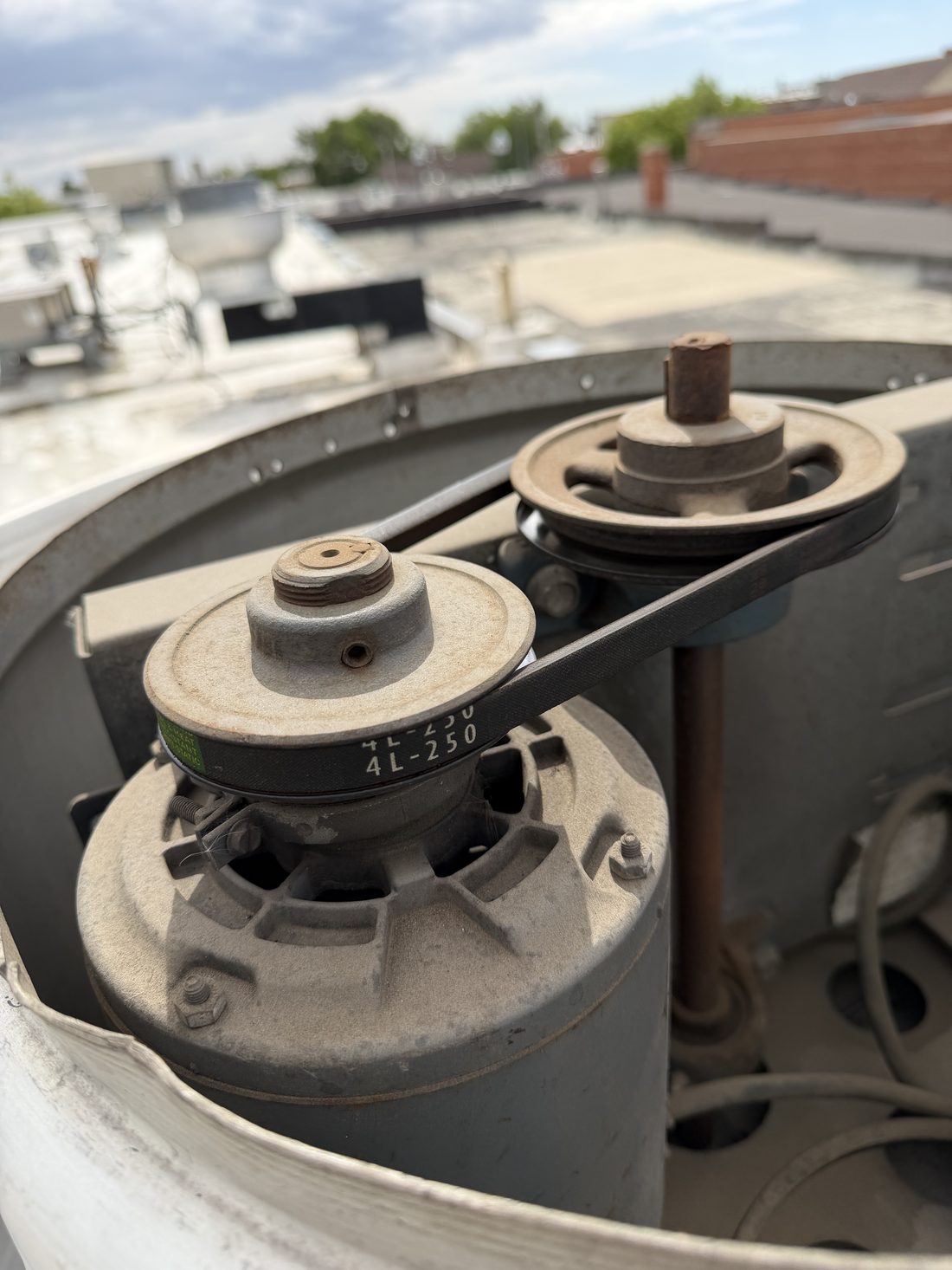 Belt-drive assembly on commercial rooftop equipment during a maintenance inspection