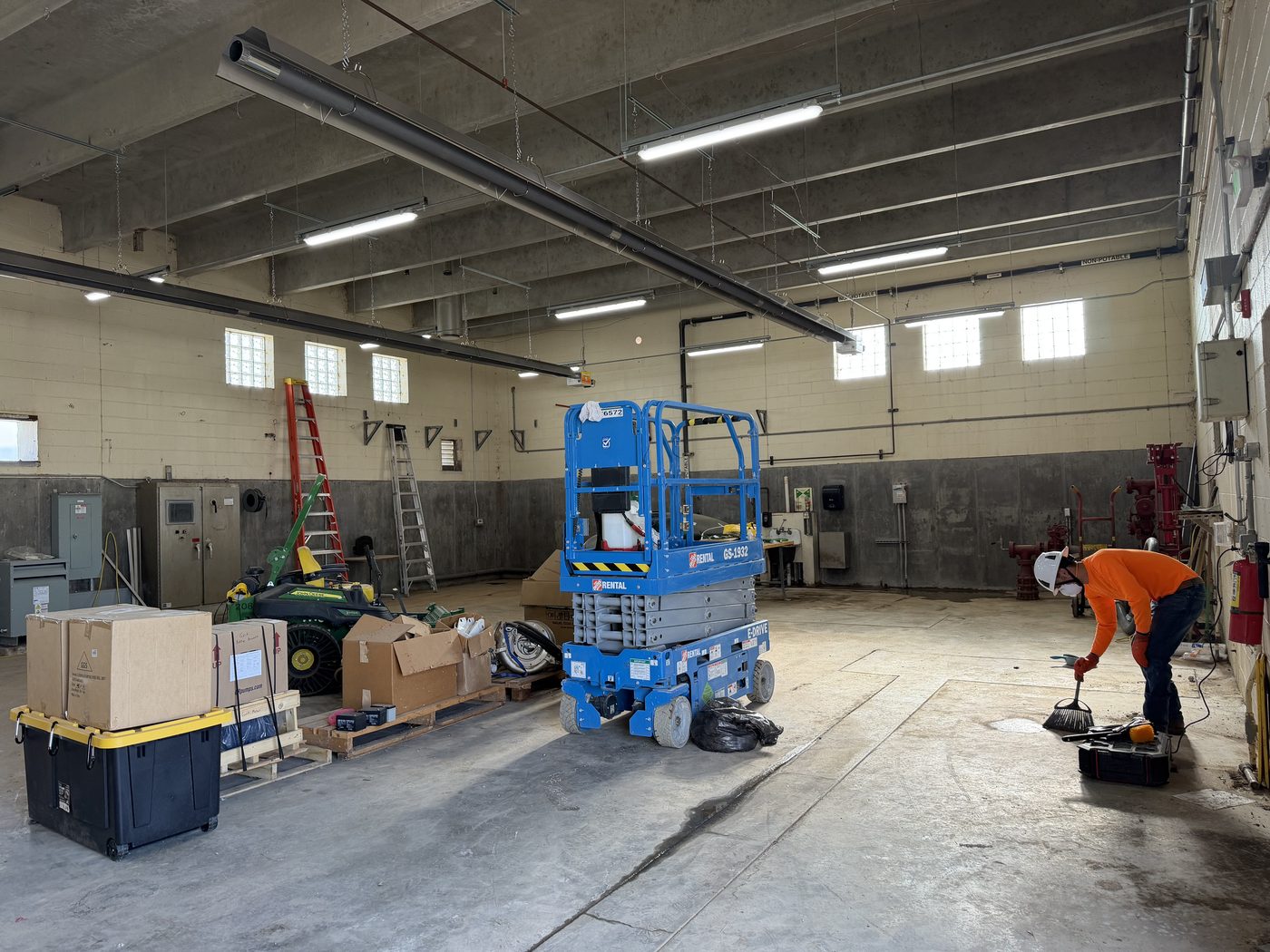 Longview technician working in a municipal utility building with overhead unit heaters